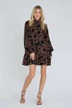 Load image into Gallery viewer, The Dranila dress is a feminine short dress in mesh with a decorative print with velour and a casual silhouette. The dress has long, voluminous sleeves and a loose fit for a light and flattering fall. A petticoat is included.

The dress is true to size. The model is 175 cm tall and wears

size S/36.- Mesh dress with velour print
- Feminine short dress

Quality: 95% Polyester, 5% Elastane
Washing instructions: Follow instructions on care label. 