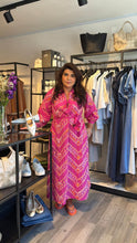 Load image into Gallery viewer, Features a bold, Mediterranean-inspired geometric and paisley pattern in pink and tangerine or

crafted from a high-quality blend of cotton, designed for breathability.

A loose, relaxed fit with long sleeves and a matching fabric belt to define the waist.

This collection is made entirely in Greece by Greek designers who focus on natural fabrics such as comfortable cotton, cool linen, and airy silk.

Our Greek heritage, architecture, and the surrounding nature all serve as sources of inspiration. O