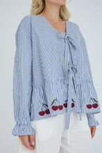 Load image into Gallery viewer, Alize blouse is a feminine blouse with a v-neck and long sleeves with elastic and ruffles. The blouse has decorative ties at the front, but is firmly closed at the bottom. The striped design is combined with fine embroidered details at the bottom, which adds a playful and elegant look.

The blouse is true to size.

- Decorative ties
- V-neck
- Long sleeves
- Embroidered details

Quality: 70% Cotton 30% Polyester