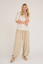 Load image into Gallery viewer, Manon balloon pants are a pair of pants with a balloon shape, which creates volume and a modern look. They have a loose cut with a narrowing at the ankles, which gives a nice silhouette. The trousers have elastic at the waist and ankles, as well as ties at the waist.

The pants are normal in size.

- Trousers with balloon shape
- Volume in the legs
- Modern and casual look

Quality: 70% Polyester, 30% Polyamid