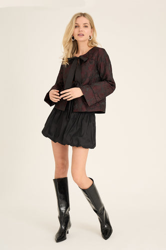 Aria Jacket is an elegant jacket in jacquard-woven material with a feminine look. It has a round neck, long sleeves and closes at the front with two bow details.

The jacket is true to size.
 Jacquard material
 Bow closure
Structured look
