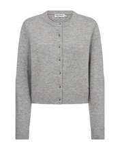 Load image into Gallery viewer, CMSIENNA-CARDIGAN is a regular-fit wool-yarn cardigan with a clean O-neck and a neat, cropped silhouette. Tonal buttons define the front, while a discreet CM metal logo charm at the hem adds a subtle signature detail, balanced by tonal embroidery below the back neckline for a refined, minimalist look.

Soft wool-yarn knit
Regular fit with cropped length
Horn look buttons
CM metal logo detail at hem
Tonal logo embroidery below the back neckline