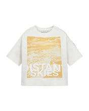 Load image into Gallery viewer, CMMUSE-TEE is a loose-fit O-neck T-shirt crafted in soft organic cotton jersey. The wide shoulders and relaxed silhouette create a modern look, while a large graphic “Distant Skies” artwork at the front adds a bold visual statement. A casual piece with a strong graphic expression.

Stretchy Organic cotton jersey
Loose fit with wide shoulders and O-neck
Bold front print adds a graphic, modern statement
Back length from shoulder seam in size S is 60 cm. All measurements are indicative and may vary