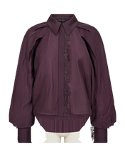 Load image into Gallery viewer, CMMOLLY-SHIRT is a loose-fit shirt in a slightly sheer, woven lyocell-polyester blend with a soft, flowing hem. The look gets a classic touch with a shirt collar and hidden button closure, while the dramatic raglan sleeves add volume and movement. Fine lace trims add a delicious, feminine twist to the casual silhouette.


Woven lyocell–polyester mix with a light, slightly sheer look
Loose fit with cool A-shape
Classic shirt collar with hidden button closure and lace along the front
Dramatic, pleated raglan 
