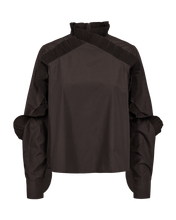 Load image into Gallery viewer, CMPLEAT-BLOUSE is a refined loose-fit blouse crafted in woven TC fabric with a crispy, structured hand feel and smooth surface. The design is defined by a high plissé collar with the plissé detailing continuing seamlessly along and around the sleeves and finishing at the buttoned cuffs, creating a sculptural, elevated silhouette.


Woven TC fabric with a smooth surface
Loose straight fit
Voluminous sleeves with buttoned cuffs
High sculptural plissé collar and invisible back zipper
Sculptural plissé effect a