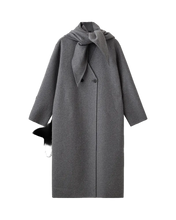 Load image into Gallery viewer, CMWILLA-COAT is a softly structured coat in a woven felted wool mix, shaped with a loose silhouette and relaxed drop shoulders. The clean V-neck front closes with a discreet double-breasted button placement, while the detachable triangular scarf adds a refined layered touch

Woven felted wool-mix
Loose fit with relaxed drop shoulders
Detachable scarf detail and side pockets
Long sleeves with a straight, minimal shape
Back length from shoulder in size S is 115 cm. All measurements are indicative and may