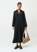 Load image into Gallery viewer, Cini dress from Créton

Details

Long dress with classic shirt collar
Deep V-neckline
Wide sleeves with wide cuffs and button details
Slits in the sides
Pleats at the back that create a nice fall

Styling
An elegant dress with a modern and exclusive look. Style it with boots and a fitted turtleneck on chilly days, or wear it with loafers and a shirt underneath for an on-trend layered look.

Fabric
67% polyester, 23% rayon, 10% spandex

A soft, dimensionally stable and stretchy fabric that provides good free