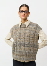 Load image into Gallery viewer, Chunky knit waistcoat with decorative cable knit
Round neck with ribbed hem
Broad shoulders with a relaxed silhouette
Ribbed hem
Melange play of colours that gives the knit extra depth

Styling