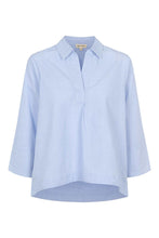 Load image into Gallery viewer, The Tali blouse from Esmé Studios is the perfect combination of Nordic minimalism and sustainable luxury. This light blue shirt is made of 100% GOTS-certified organic cotton that feels soft against the skin and gets better over time.

Designed for the modern wardrobe
With its clean silhouette and timeless colour, the Tali blouse goes just as well with tailored trousers in the office as it does with casual jeans on the weekend. The light blue shade adds a breath of fresh air to spring and summer looks.


