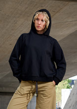 Load image into Gallery viewer, A soft hoodie designed in organic cotton with a relaxed and slightly boxy silhouette for everyday comfort. The loose fit creates a cool and effortless look, while the clean design keeps the style calm and easy to wear across seasons. Comfortable and versatile, it works naturally as part of both relaxed everyday dressing and slower weekend moments. A casual wardrobe favourite designed for comfort and simplicity.

Style it with jeans for an easy everyday outfit or pair it with soft leggings for relaxed days a