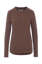 Load image into Gallery viewer, A refined jersey blouse designed with a timeless high neckline and an elegant silhouette. Made from soft ECOVERO™ jersey, it combines everyday comfort with a polished look that works effortlessly across seasons. The extra-long slim sleeves create a sophisticated expression, while signature grosgrain ribbons at the neck and cuffs add subtle HSCPH details. A versatile wardrobe piece designed for both relaxed and more dressed-up styling.
Wear it with lounge trousers on slower days at home or pair it with jeans