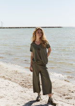 Load image into Gallery viewer, LOOSE FIT - CHECK STYLE GUIDE
Soft jersey pants designed in a straight fit with a double waistband that adds a simple, stylish detail. You can fold the waistband just as you prefer to create the look you like best.
This style comes in two lengths - choose this version for a shorter ¾ length, or explore style 99016 if you prefer a longer, full-length silhouette.
The perfect pants for a comfortable feeling with a refined touch. Style them with a matching jersey T-shirt and add a fleece cardigan or poncho for 