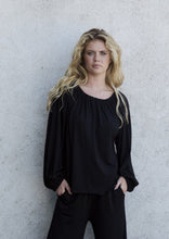 Load image into Gallery viewer, An all-day blouse with an elegant and light expression. 
Crafted from soft viscose jersey, finished with hidden elastic at the neckline and cuffs, allowing the fabric to drape beautifully and add gentle volume to the sleeves.
The boxy, cropped silhouette adds a modern touch to the elegant style. Pair it with a pair of jersey pants or a matching skirt for a complete look.

- 100% EU production 
- 96% viscose ECOVERO™, 4% EA
- OEKO-TEX® STANDARD 100 cert. no. 2176-347 DTI
- Machine wash, hang to dry