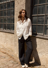 Load image into Gallery viewer, A relaxed shirt with a loose boxy fit, long sleeves, and a casual collar, finished with a cool pocket detail on one side. Button closure at the front and on the sleeves allows you to adjust the fit - wear the sleeves loose for a relaxed look or button them for a more defined fit.