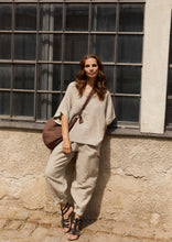Load image into Gallery viewer, Baggy trousers with a voluminous, balloon-shaped silhouette. Cut to an ankle length and designed with side pockets and an elastic waistband for everyday comfort.

- 100% EU production
- 100% pure natural hemp
- OEKO-TEX® STANDARD 100 cert. no. 2176-347 DTI