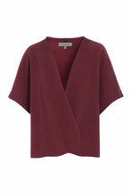 Load image into Gallery viewer, An elegant vest with a cropped, loose fit, designed with side slits and large arm openings for easy layering. Finished with signature grosgrain band details for a refined touch.
A versatile piece that works across all seasons – perfect for a breezy summer evening or layered over a sweater when the temperature drops.
- 100% EU production
- 70% polyester min. 50% recycled
- 30% viscose
- OEKO-TEX® STANDARD 100 cert. no. 2176-347 DTI
- Machine wash, ready to wear after a few hours