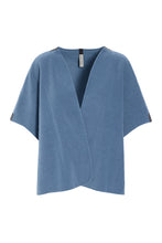 Load image into Gallery viewer, An elegant vest with a cropped, loose fit, designed with side slits and large arm openings for easy layering. Finished with signature grosgrain band details for a refined touch.
A versatile piece that works across all seasons – perfect for a breezy summer evening or layered over a sweater when the temperature drops.
- 100% EU production
- 70% polyester min. 50% recycled
- 30% viscose
- OEKO-TEX® STANDARD 100 cert. no. 2176-347 DTI
- Machine wash, ready to wear after a few hours