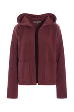Load image into Gallery viewer, A cardigan with a more sporty look, designed with long sleeves, practical pockets, and a hood. The boxy, cropped silhouette creates a relaxed and modern feel.
Style it with matching fleece pants, a jersey T-shirt, and your favourite sneakers for a comfortable everyday look.
- 100% EU production
- 70% polyester min. 50% recycled
- 30% viscose
- OEKO-TEX® STANDARD 100 cert. no. 2176-347 DTI
- Machine wash and hang to dry, ready to wear after a few hours