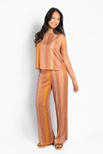 Load image into Gallery viewer, Lightweight trousers with wide legs, made of soft and supple viscose for an airy summer feel. Designed with a relaxed fit and elastic waist, and adorned with HÉST's signature pattern throughout the garment for a sophisticated graphic expression. Comfortable and stylish, a simple statement piece for a modern summer wardrobe.


Material: 100% Viscose