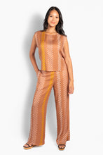 Load image into Gallery viewer, A lightweight, sleeveless top made of soft and supple viscose for an airy summer feel. Designed with a relaxed silhouette and a soft drape, and adorned with HÉST's signature pattern across the entire garment for a sophisticated graphic touch. Casually elegant, a stylish statement piece that elevates your everyday look.


Material: 100% Viscose