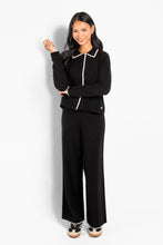 Load image into Gallery viewer, The Vivienne Pants are designed with a wide-leg silhouette and a clean, relaxed feel. Crafted from merino wool, they offer warmth while remaining soft, lightweight, and comfortable. Finished with an elasticated waistband and subtle contrast detailing at the hem for a refined, graphic touch. A versatile style that pairs effortlessly with the matching Vivienne Cardigan or Sweater for a coordinated look.