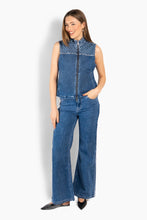 Load image into Gallery viewer, A denim vest with a structured yet relaxed silhouette. It features a full zip front, stand collar, and subtle HÉST-inspired pattern detailing at the yoke for a distinctive touch. Versatile and contemporary, it’s an easy layering piece that adds a cool, refined edge to everyday looks.