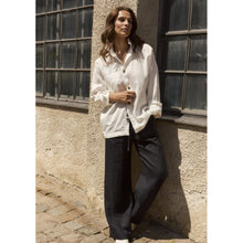 Load image into Gallery viewer, Hemp pants with a light and relaxed expression, shaped with flared legs in a full-length silhouette. Designed with practical side pockets and finished with ties at the front for an easy, adjustable fit.
- 100% EU production
- 100% pure natural hemp
- OEKO-TEX® STANDARD 100 cert. no. 2176-347 DTI