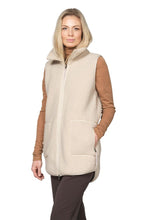 Load image into Gallery viewer, Easy layering with a soft touch. This long soft pile vest brings warmth and comfort without the sleeves. A decorative grosgrain front zipper and a tall, comforting collar set the tone, while stitched side pockets accented with grosgrain tape add a refined, tactile detail. Even the zipper pullers are finished with grosgrain and a printed Ilse Jacobsen logo. The gently rounded hemline at the back brings a feminine softness to the silhouette, and a subtle rubber logo at the back completes the look.

Materials: