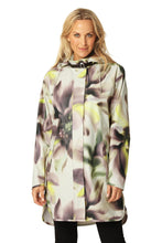 Load image into Gallery viewer, Designed with a straight silhouette, this raincoat offers a sleek, modern look. Crafted from lightweight, waterproof rubberized PU fabric with a soft tricot backing, it is enhanced with a bold, all-over floral print. Double-welded seams enhance its resilience, while the detachable hood, secured with an artificial leather neck strap, adds versatility. Side seam slits and a YKK 2-way zipper hidden under a storm placket balance functionality with style. Practical yet refined.