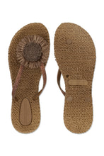 Load image into Gallery viewer, Step into summer with effortless elegance. These charming flip-flops combine beauty and comfort in one light, flexible design—ideal for beach walks, garden gatherings, or warm days in the city. A shimmering thong strap and bold decorative flower elevate this casual essential into a feminine statement piece. With their air-infused sole and gentle massage effect, they’re designed to keep your feet happy all day long.

Lightweight sole with induced air for flexibility and comfort
