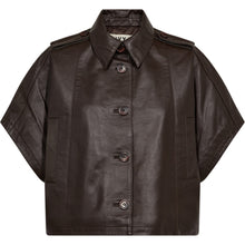 Load image into Gallery viewer, he Kylie Katee Leather Cape is crafted in smooth espresso brown leather with a clean oversized silhouette. Designed with structured shoulders, wide short sleeves and a cropped shape, it brings a modern edge to classic leather outerwear while remaining effortless to layer.
Size &amp; Fit
• Oversized fit
• Cropped silhouette
• Wide short sleeves
Details
• Smooth leather finish
• Button closure
• Side pockets
