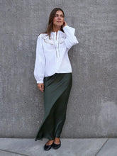 Load image into Gallery viewer, An elegant shirt with embroidered details on the front. The shirt features puff sleeves and is finished with a cuff. The model is wearing size 36.