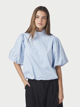 Load image into Gallery viewer, A beautiful blouse with puff sleeves and a ruffled hem. The blouse features a small collar and delicate decorative details on the left shoulder. The model is wearing size 36