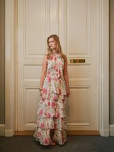 Load image into Gallery viewer, Long flower dress that ties at the neck. The dress has smocking under the bust and a loose skirt at the bottom. The model is 176 cm tall, and is wearing a size 36.