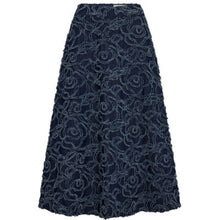 Load image into Gallery viewer, Dixie Denim Skirt is designed with a flattering high waist and an elegant A-line silhouette. Crafted from rinse-wash denim, the skirt is elevated by intricate floral embroidery with softly frayed edges, creating rich texture and dimension throughout.
Size &amp; Fit
• High Waist
• A-line silhouette
• Midi length
Details
• Rinse-wash denim base
• All-over floral embroidered appliqué
• Concealed back zip closure
• Fully lined