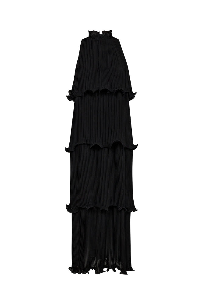 pleated tiers, this sleeveless maxi dress creates graceful movement with every step.
The high neckline is softly gathered with delicate ruffle detailing, adding a touch of romantic contrast to the architectural silhouette.
Ideal for evening occasions or elevated daytime dressing, it’s a standout piece with effortless allure.
Size & Fit
• Relaxed, flowy fit
• Full-length silhouette
• High ruffled neckline
Details
• Tiered pleated design
• Button closure at neck
• Sleeveless construction
• Lightweight fab