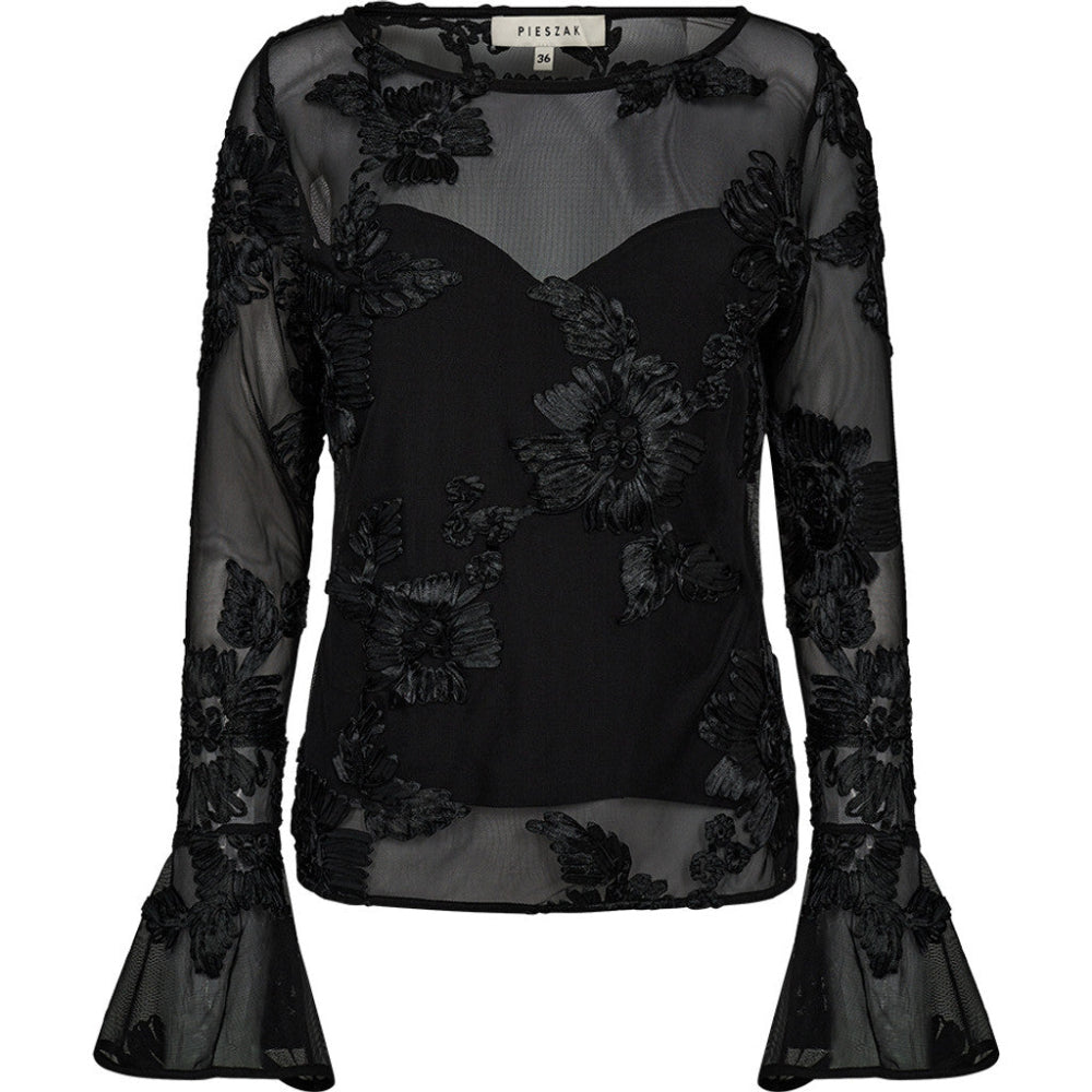 The Melia Flounce Sleeve Mesh Blouse brings a romantic edge to evening dressing. Crafted from sheer mesh with intricate tonal embroidery, the silhouette is soft and structured with a fitted inner bodice and subtle bell sleeves.
A statement piece that balances delicacy and drama - perfect for elevating tailored trousers or denim with ease.
Size & Fit
• Fitted inner bodice
• Semi-sheer sleeves and back
• Hip length
Details
• Embroidered mesh overlay
• Bell sleeves
• Lightweight and lined through the body