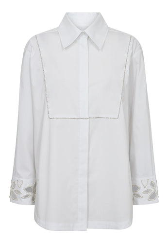 Dahlia Long Shirt is a contemporary update to the crisp white shirt. Designed with a decorative front flap detail and delicate embellishment along the cuffs and shoulders, it blends tailoring tradition with modern femininity.
The slightly A-line silhouette ensures an effortless fit, while the clean lines and hidden placket add a minimalist finish.
Size & Fit
• Regular fit
• Slightly A-line shape
• Hip length
• Long sleeves
Details
• Classic cotton shirt with elevated details
