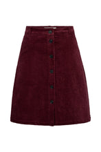 Load image into Gallery viewer, The Gilly Skirt offers a modern take on retro-inspired tailoring. Cut from soft corduroy with a structured yet comfortable feel, this A-line silhouette is designed to sit high on the waist and finishes just above the knee.
The full button-through front and clean waistband bring a crisp, minimal finish
Size &amp; Fit
• High-rise waist
• A-line silhouette
• Above-knee length
Details
• Button-through front
• Belt loops
• Side pockets
• Soft corduroy with subtle stretch