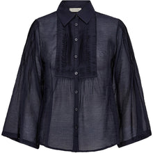 Load image into Gallery viewer, Chris Pintuck Shirt is a lightweight sheer blouse designed with pintuck detailing for a refined, feminine expression. Cut from soft, slightly structured fabric, it has a loose silhouette with wide sleeves, a classic collar and a subtle pleat at the waist for gentle volume.
Size &amp; Fit
• Relaxed fit
• Cropped length
• 3/4 wide sleeves
Details
• Semi-sheer, lightweight fabric
• Pintuck details at front and sleeves
• Button-down closure
• Classic shirt collar
• Unlined