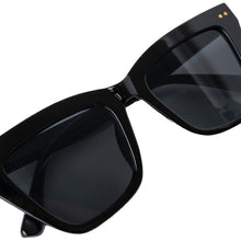 Load image into Gallery viewer, Glam sunglasses for women with oversized frames. Characteristic graphic 70’s Cat-eye style with tinted glasses.
• One size
• Tinted glasses
• 100% recycled polycarbonate
• Delivered in a small organic cotton bag