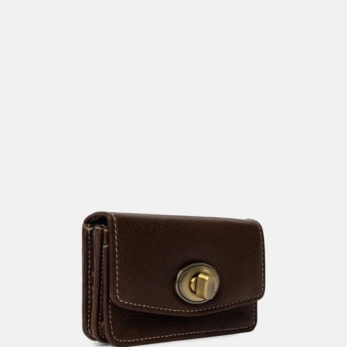 Wallet Small is a sleek and minimalist wallet designed for everyday elegance. It features a refined gold clasp closure that adds a subtle touch of sophistication. On the back, you'll find a practical zip pocket, and inside, the wallet includes a zip compartment and two open sections - perfect for organizing your cards and small essentials.