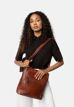 Load image into Gallery viewer, Myra Big is a chic and practical bag, perfect for everyday use. It features a stylish front zip pocket, ideal for keeping small essentials within easy reach. Inside, you&#39;ll find a spacious main compartment that offers plenty of room for all your on-the-go necessities. The bag comes with both a shoulder strap and a crossover strap, giving you versatile carrying options to suit your style and comfort.