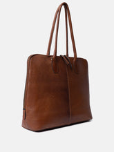 Load image into Gallery viewer, Handcrafted
• Two sturdy handles
• Metal zipper closure
• Spacious main compartment
• Comes with a detachable, adjustable crossover strap

This bag is made from our Urban Leather Quality - a milled cow leather that is dyed
before the surface is finalized. This process preserves the leather’s natural texture, leaving each bag with unique characteristics, where no two are the same. After the dye, a light wax is applied, creating a smooth and soft finish.

