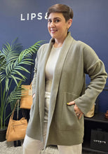 Load image into Gallery viewer, A relaxed cardigan made with a soft shape and mid-thigh length.
It features a shawl collar, practical pockets, and the signature grosgrain band that reflects the DNA of Henriette Steffensen Copenhagen.
A wardrobe essential that’s easy to style with most outfit combinations to keep you comfortable and cool. This cardigan brings warmth, simplicity, and a calm, refined look to your everyday style.
